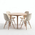 Round dining table with wooden legs and four beige plastic chairs
